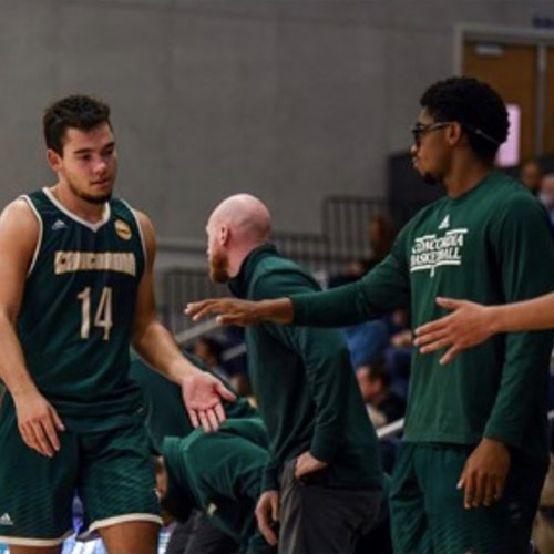 Kayle Knuckles high-fiving his coaches and teammates against Chaminade